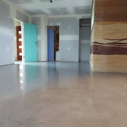 Reflective polished concrete floor in a bright home interior